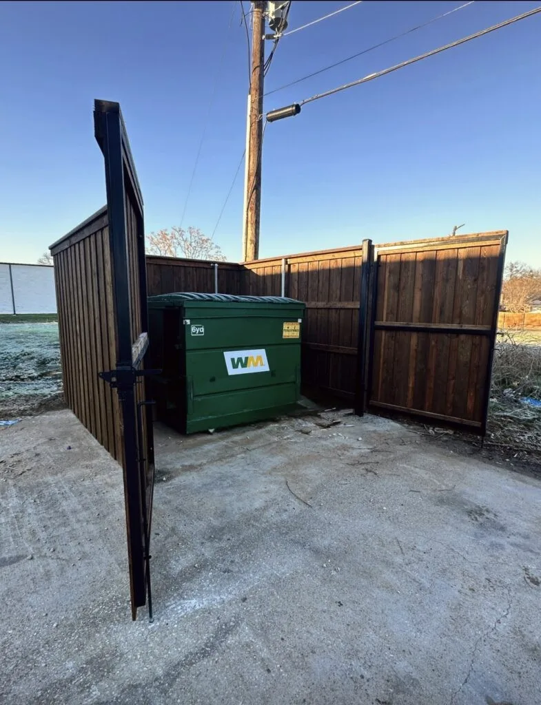 Commercial cedar and steel dumpster enclosure in Pearland TX