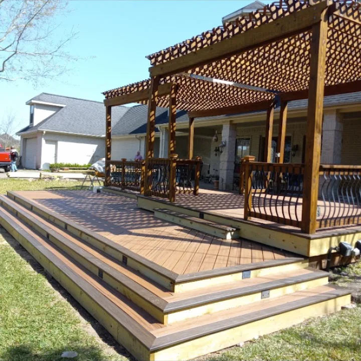 Multi-level composite deck with stained lattice pergola and iron railing in Pearland TX