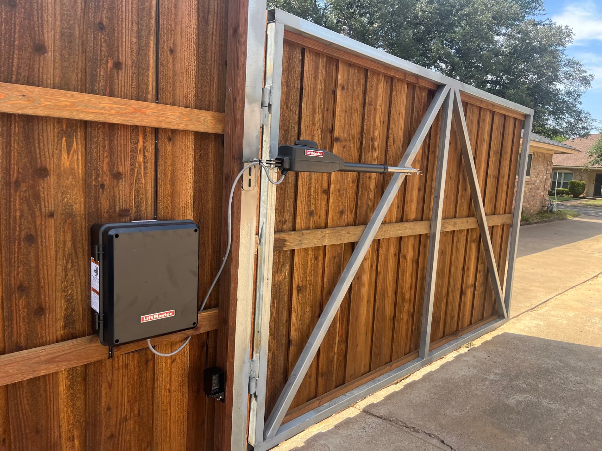 Cedar swing driveway gate with LiftMaster operator in Houston TX